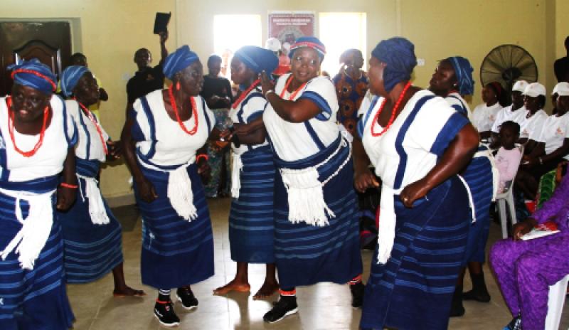 Traditional singers and dancers entertaining the audience with a theme act on pregnancy and childbirth