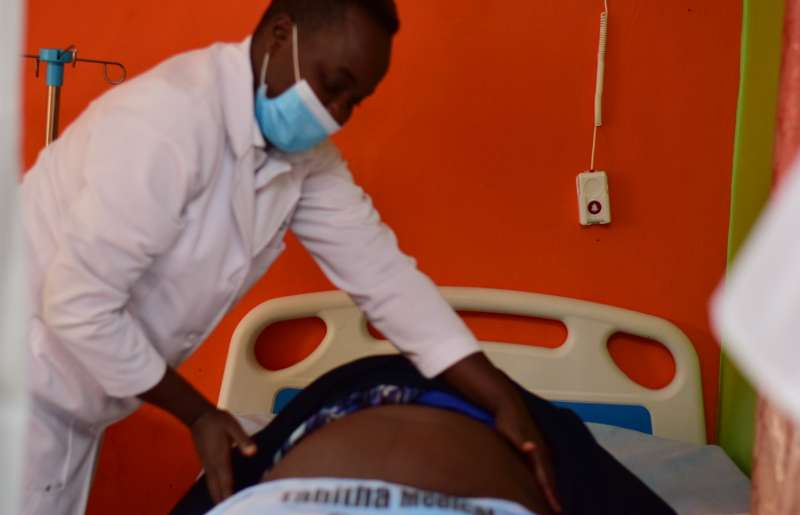 Nurse at a Nairobi private clinic attending to a mother